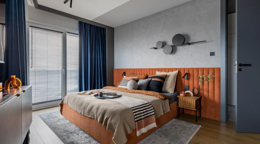 A bedroom featuring blue made-to-measure curtains