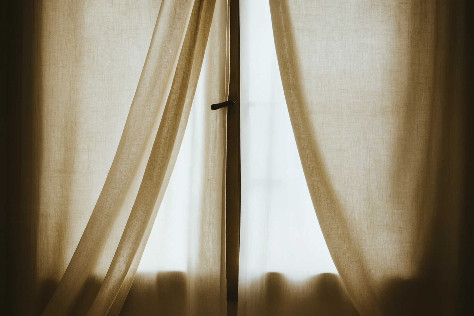 Sun coming through light made-to-measure curtains in bedroom